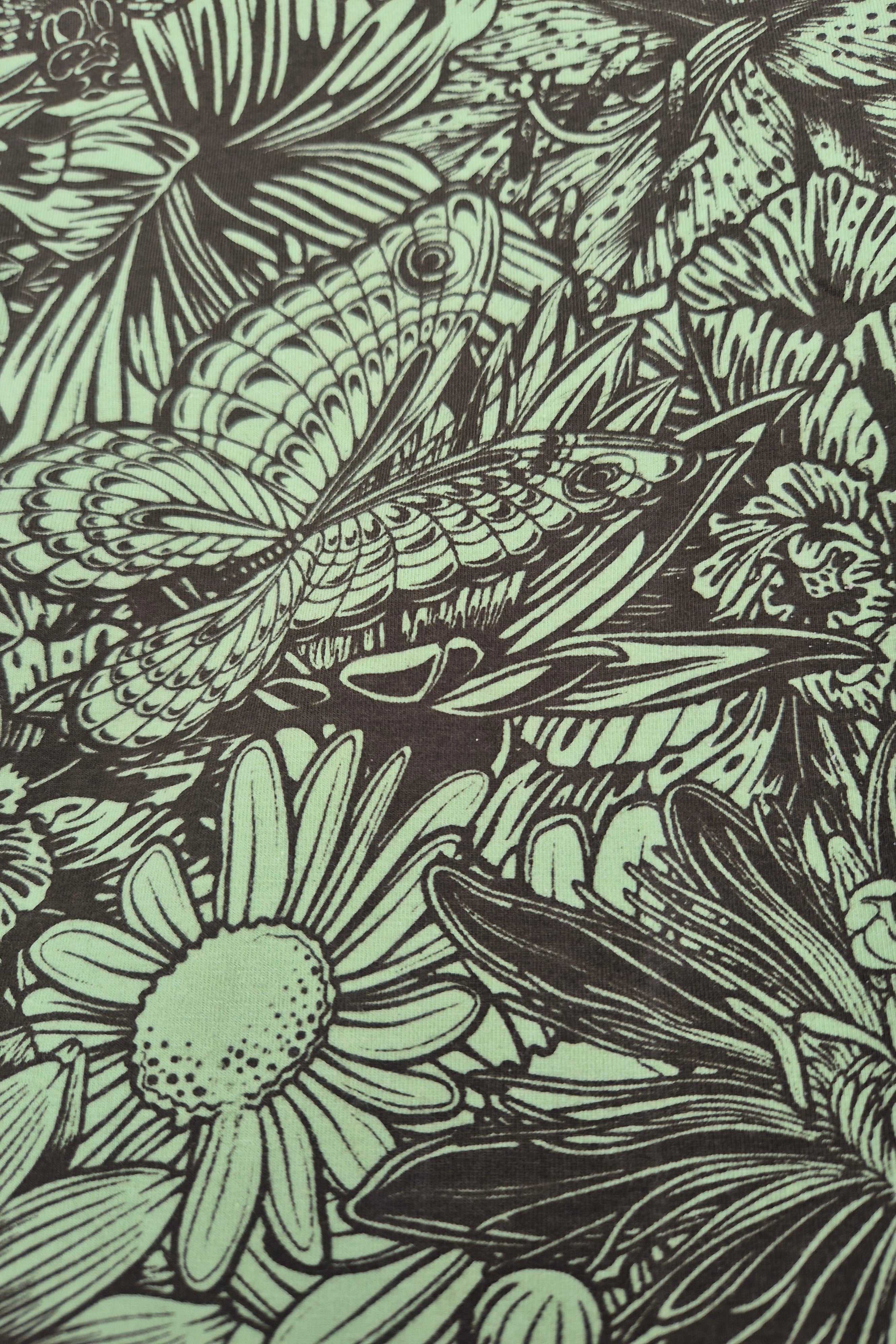 Bloom print of flowers, butterflies and dragon flies in olive and green on cotton stretch material