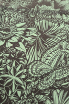 Bloom pattern of butterflies, dragonflies, flowers and leaves on a green background