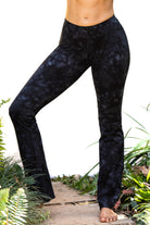 A woman wearing Funky Simplicity black smokey flared leggings shown from the front.