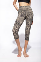 Woman wearing cream black feather printed capri leggings made from cotton lycra shown from the front - funky simplicity