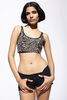 Model wearing Wild animal printed cross back bra with a black cotton lycra jeans shorts shown from the front